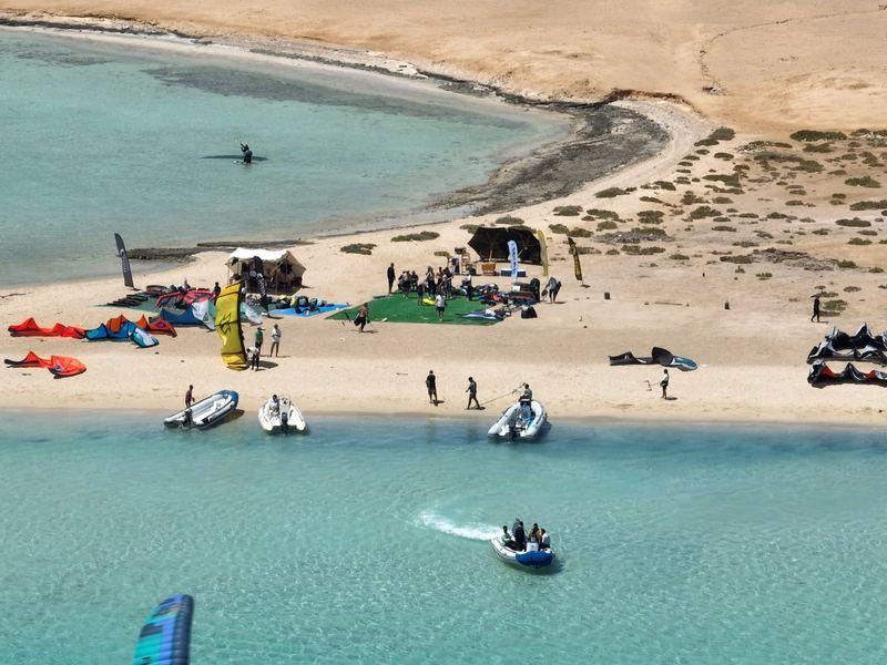 Beach camp on a Red Sea island with kites, shade tent and rescue boats