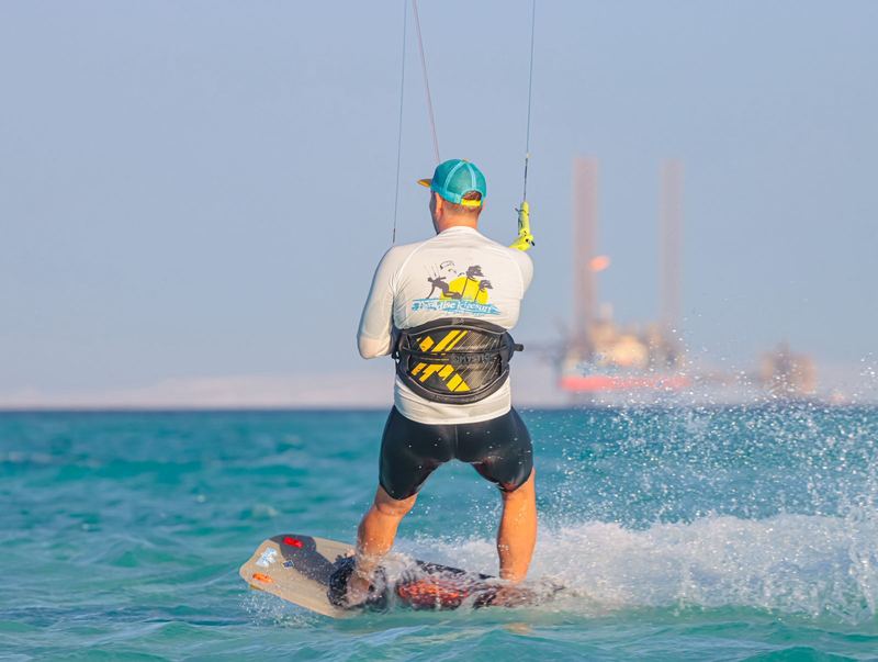 Kiter riding away from the camera, seen from behind