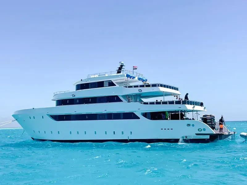 M/Y Hermes from the side, three decks above blue water