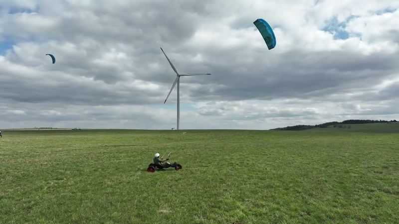 Kite buggy in a meadow near Fojtovice under a wind turbine