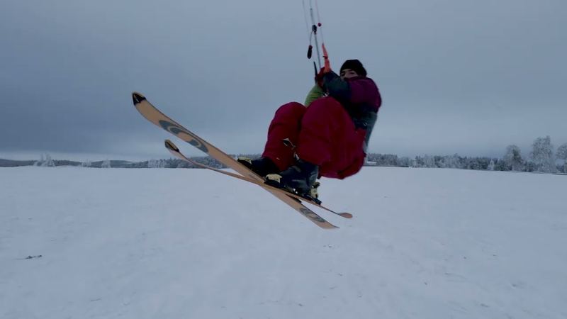 Ski jump with a foil kite over a snowy plateau